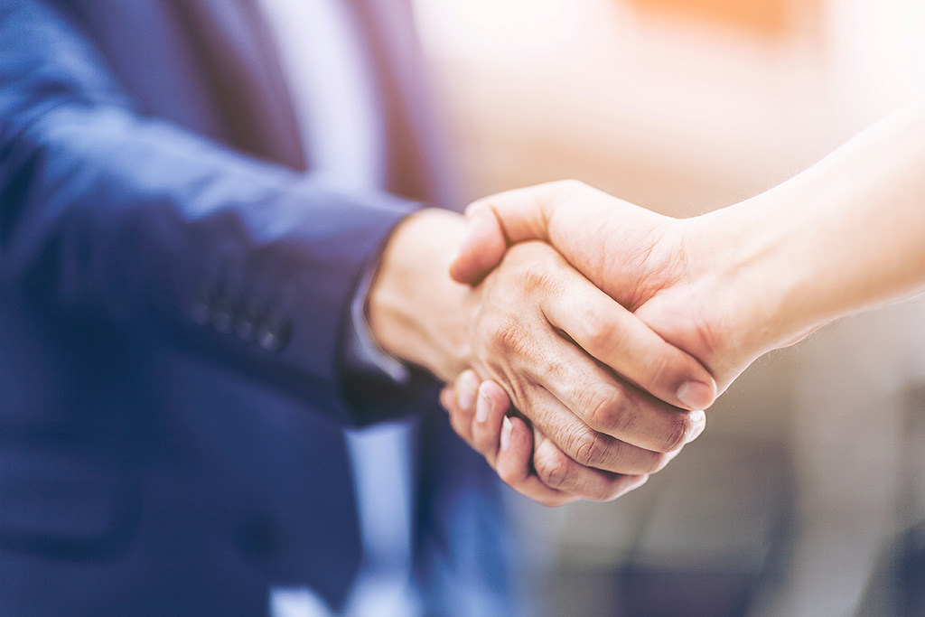 two people shaking hands together indicating an agreement